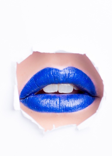 A face showing a nose and blue lips on a white background.