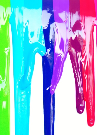 Rainbow paint colors dripping down a wall.