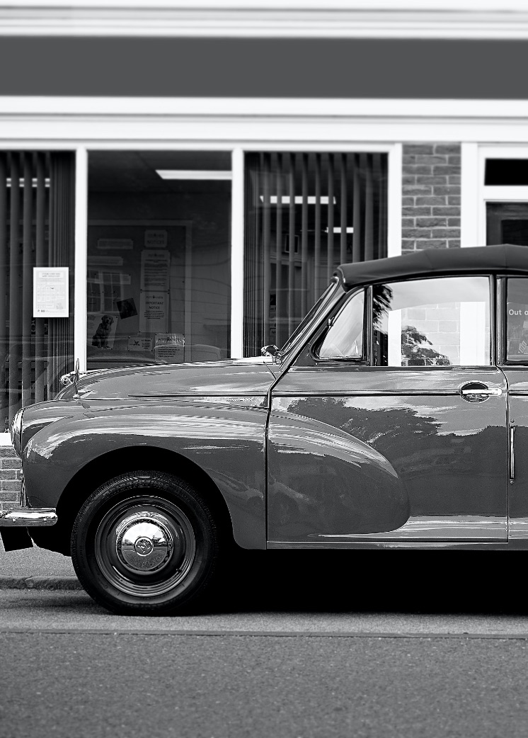 Vehicles: 1930's car on street.